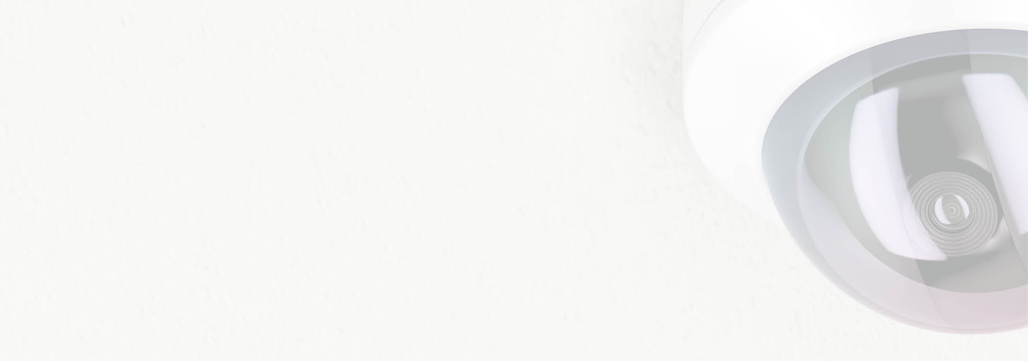 Surveillance camera attached on white ceiling 