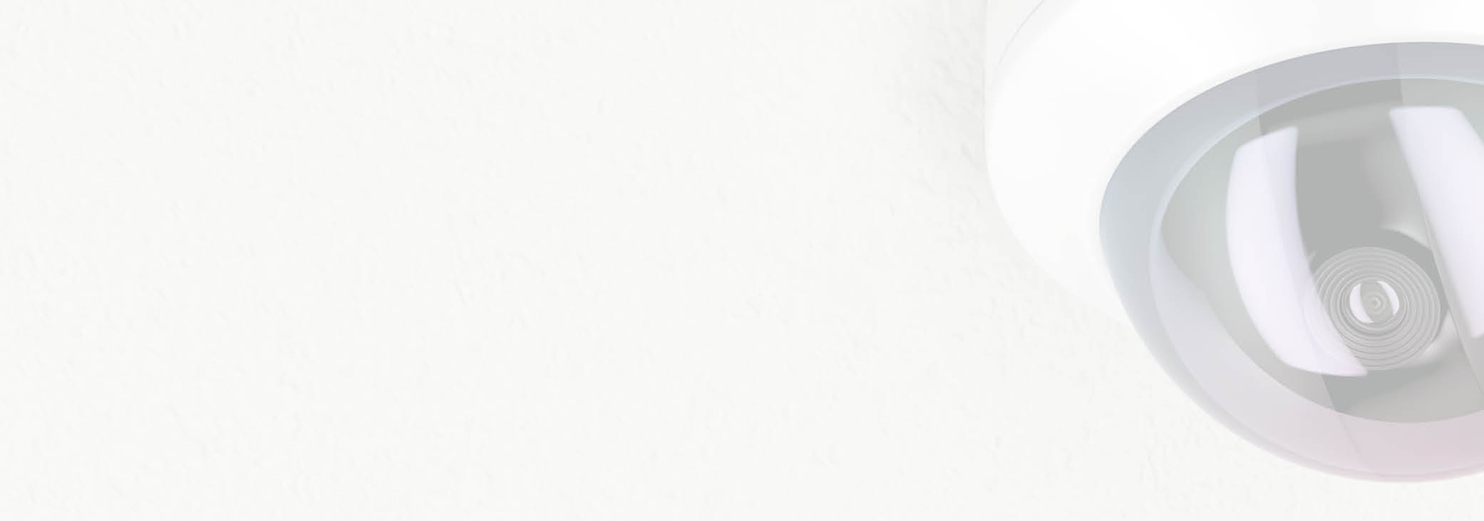 Surveillance camera attached on white ceiling 