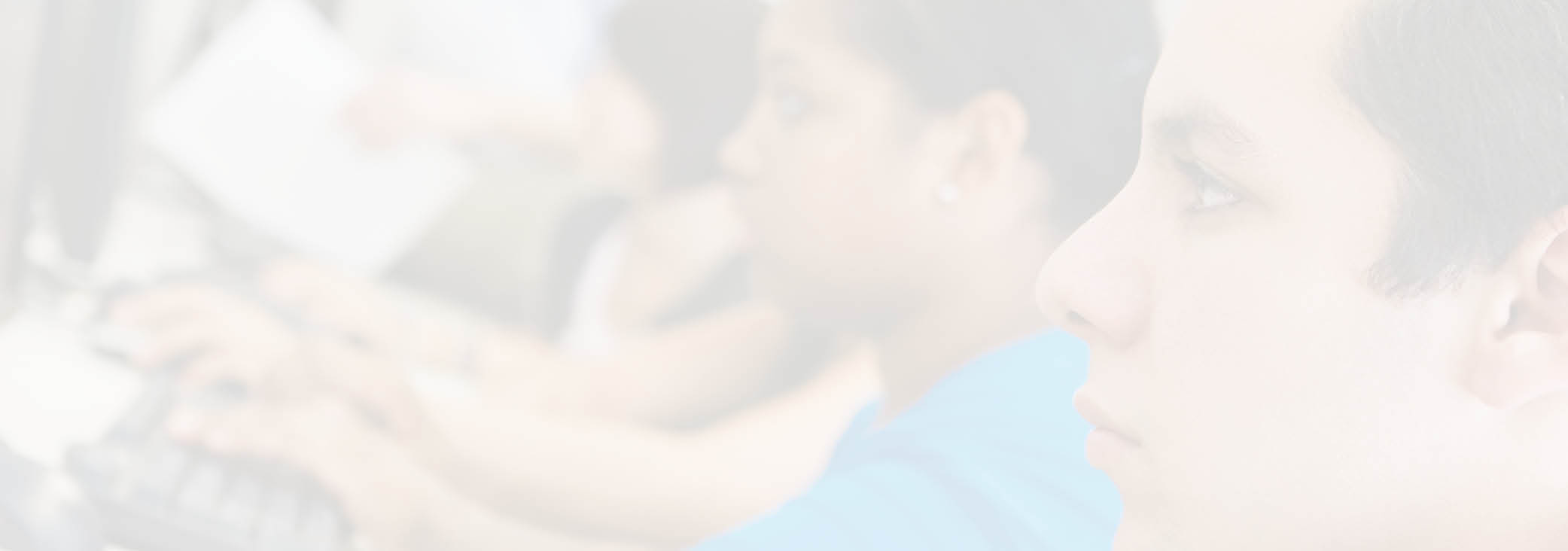 Multiethnic students using computer with professor in lab