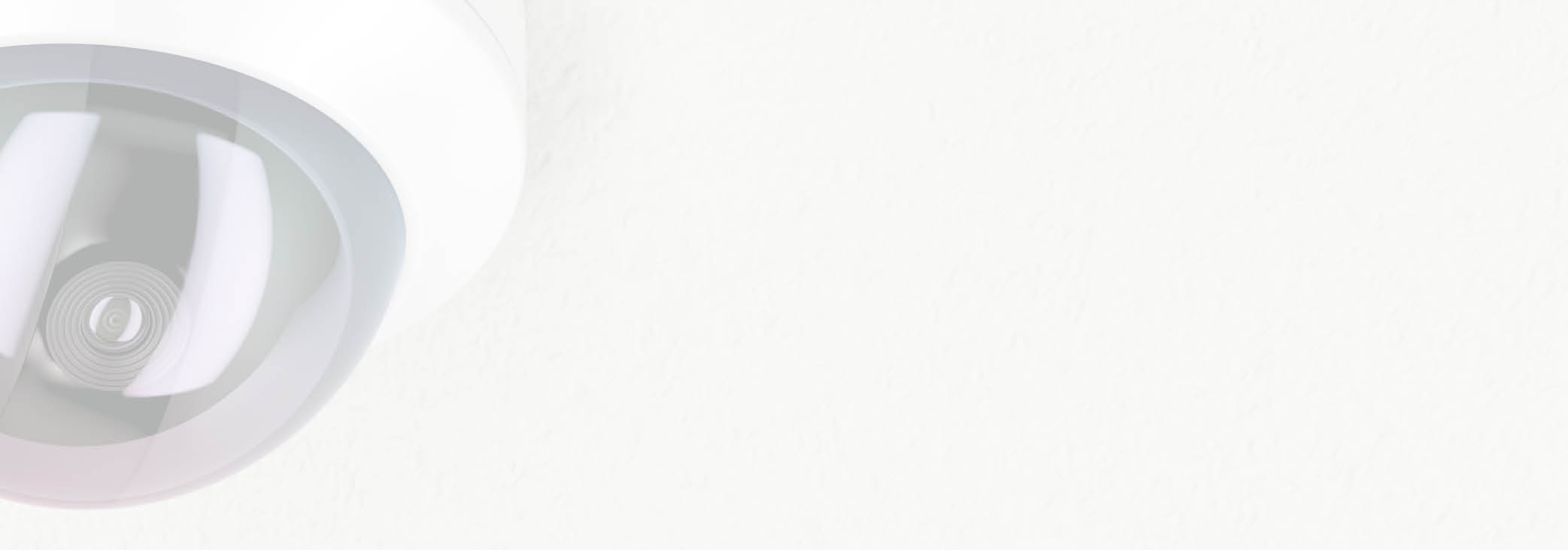 Surveillance camera attached on white ceiling 